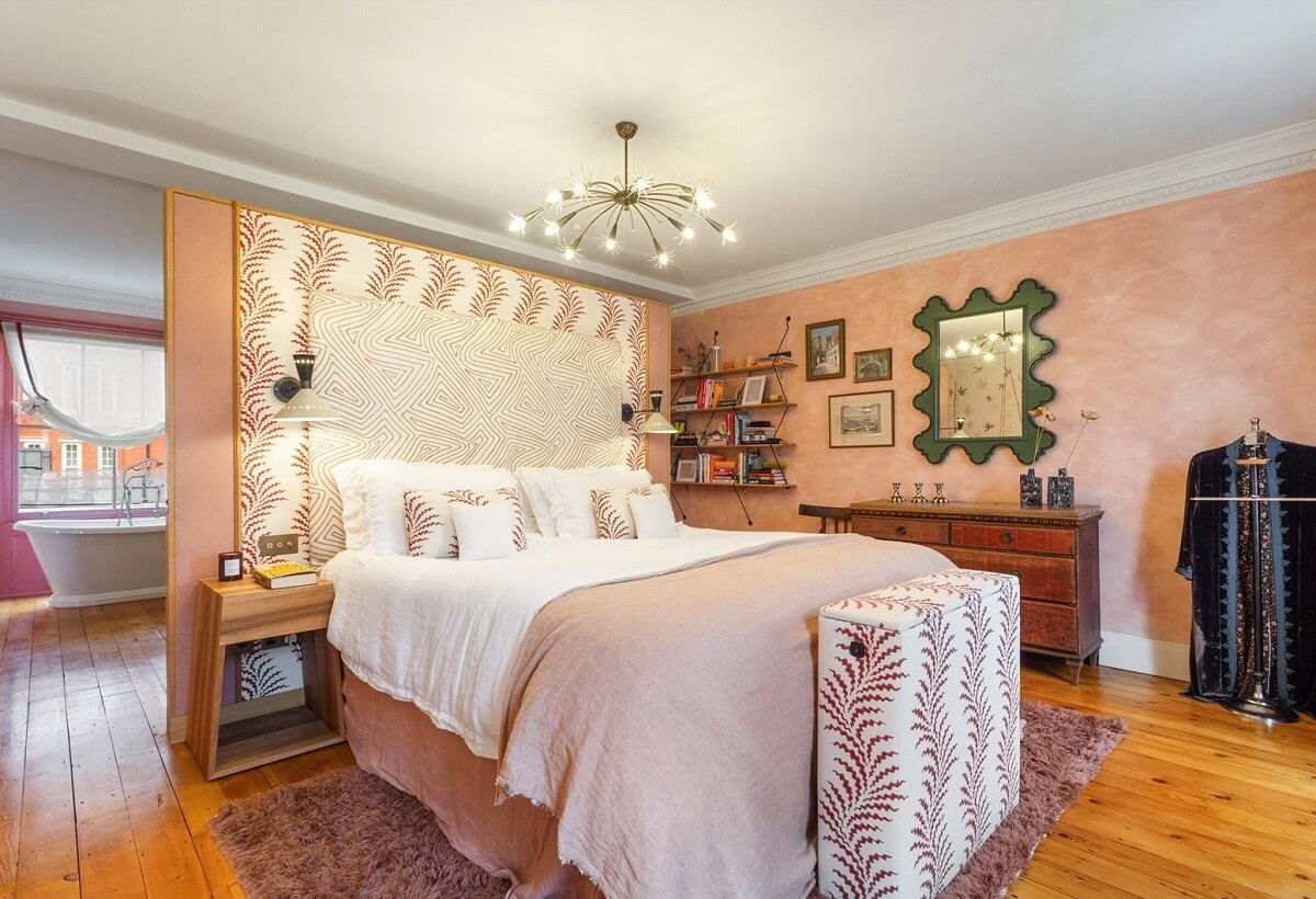 Limewash Paint and Artisan Wallpaper in a London Townhouse 26 pink master bedroom with wooden floor and en suite bathroom