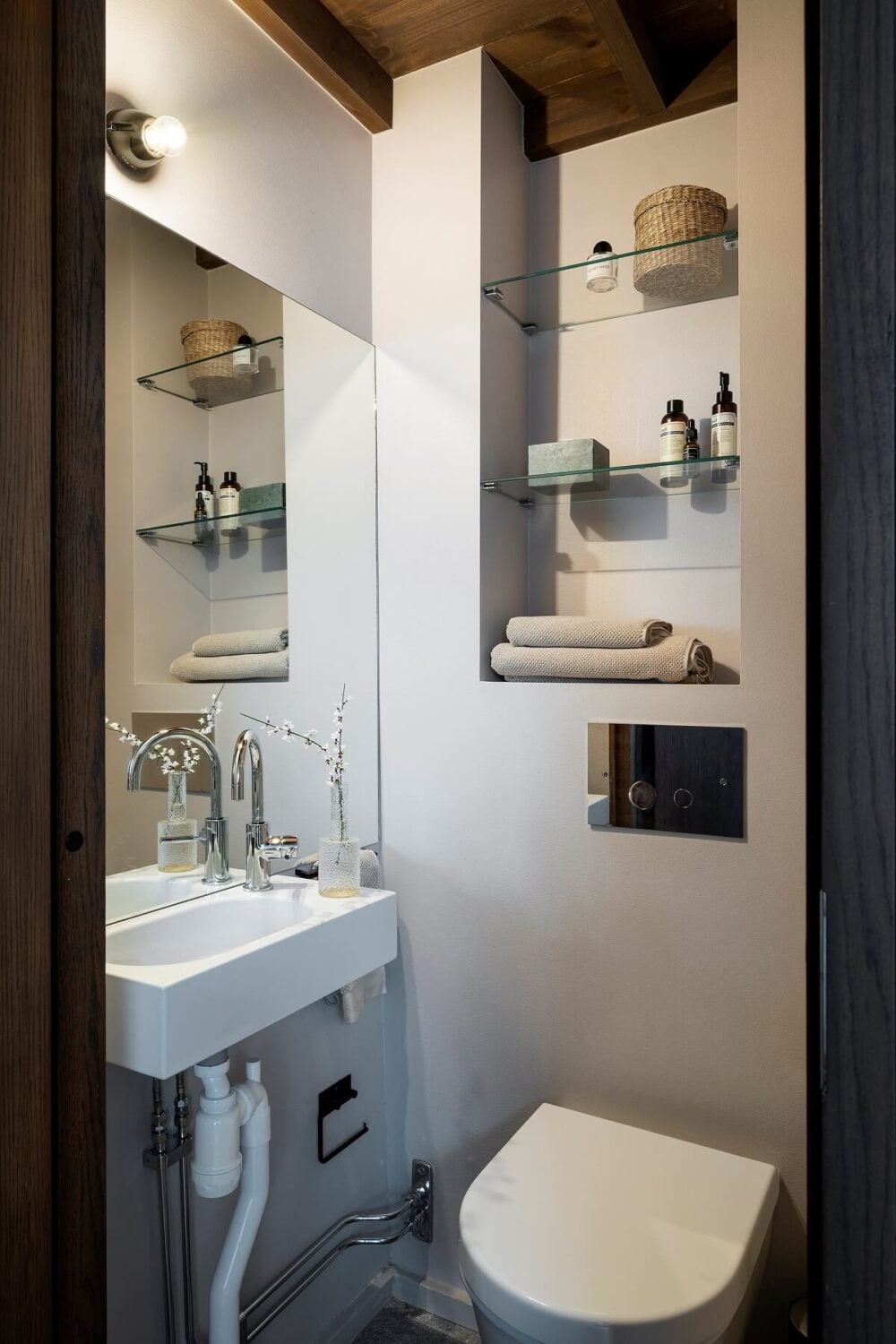 A Stylish Scandinavian Duplex with Custom-Made Cabinets 13 powder room with glass shelves