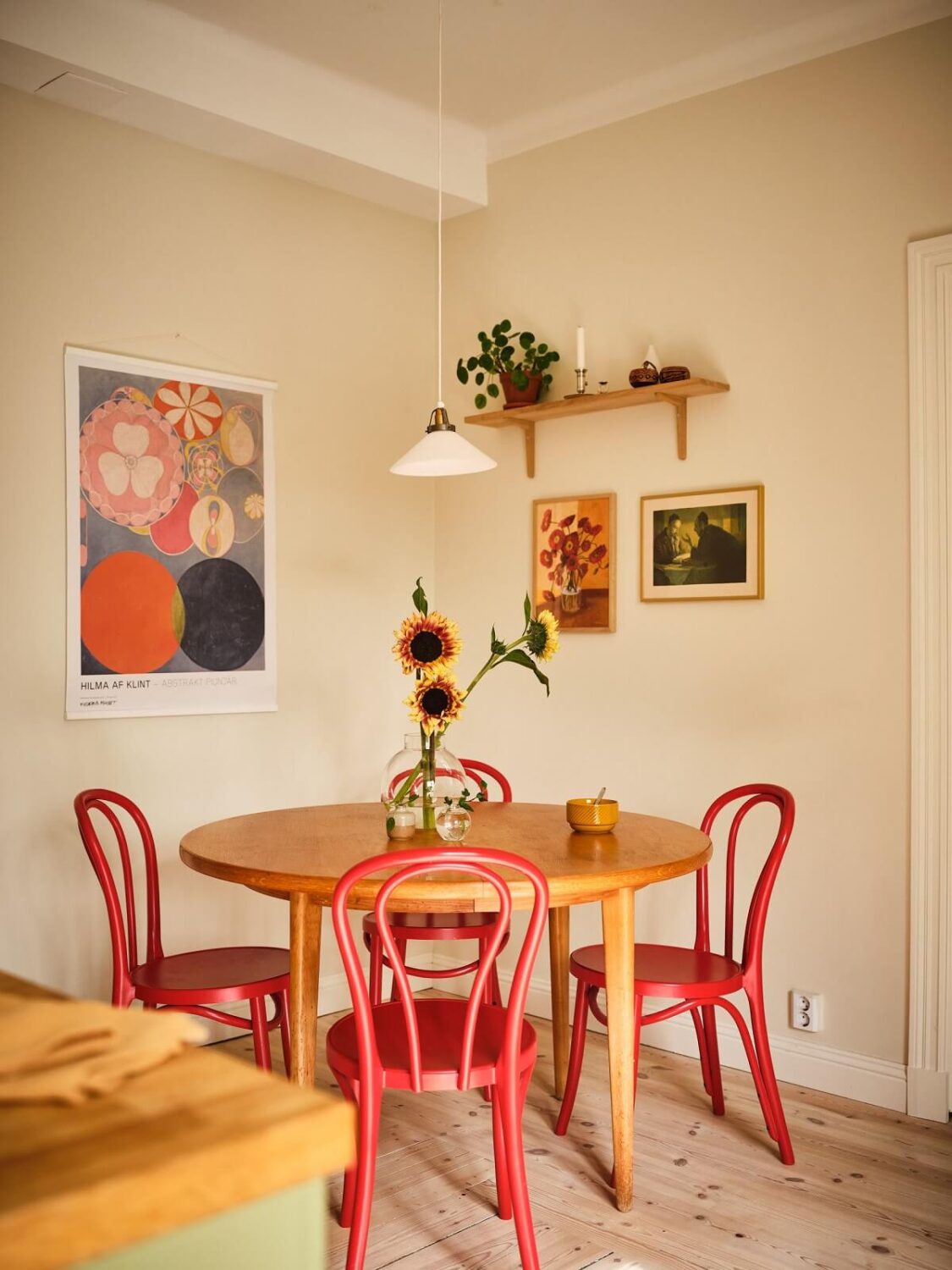 A Light Apartment with a Sage Green Kitchen 11 round dining table red chairs A Light Apartment with a Sage Green Kitchen