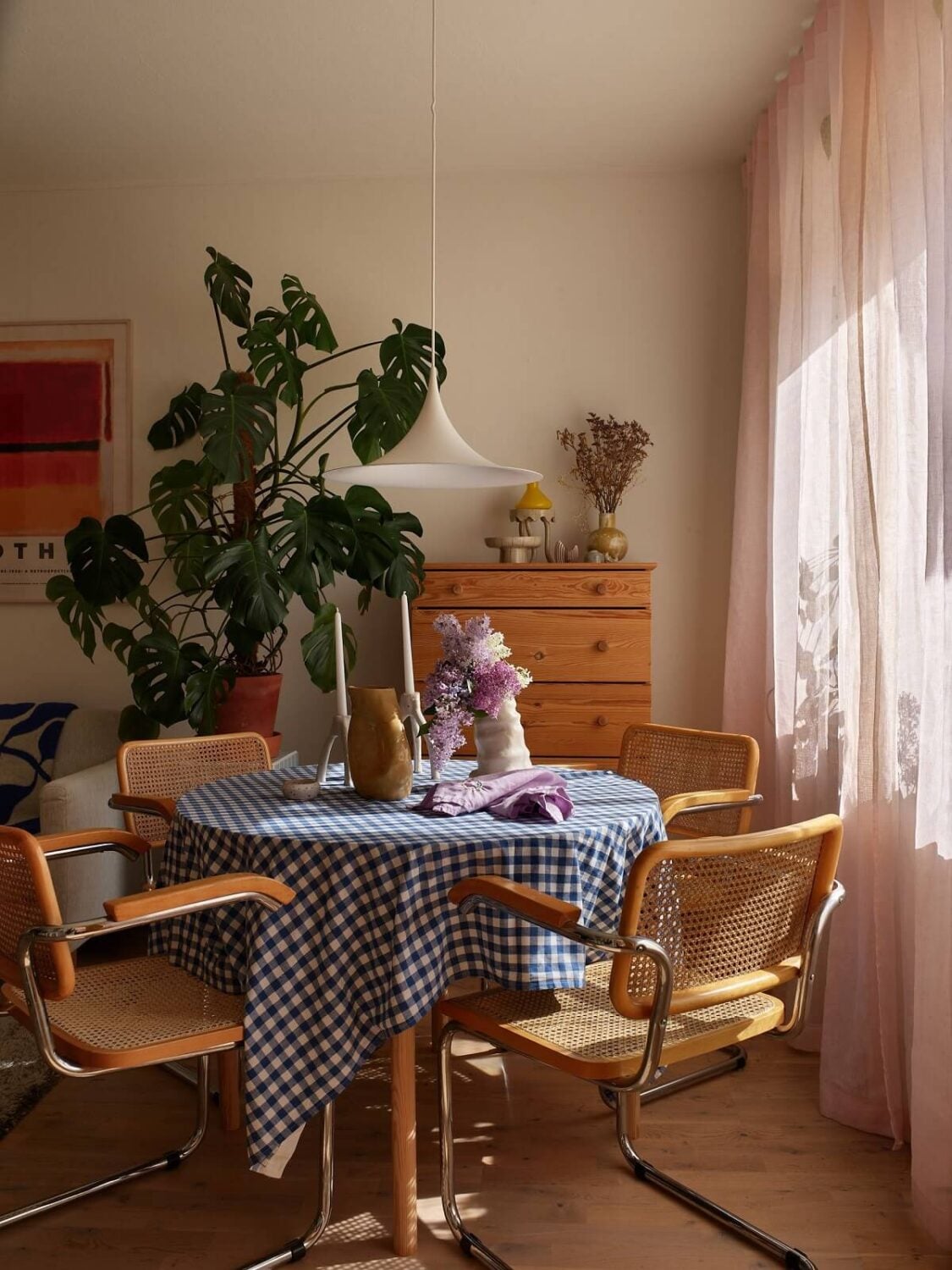 A Small Light Filled Apartment with Plants and Color 8 round table with blue tablecloth and vintage chairs nordroom