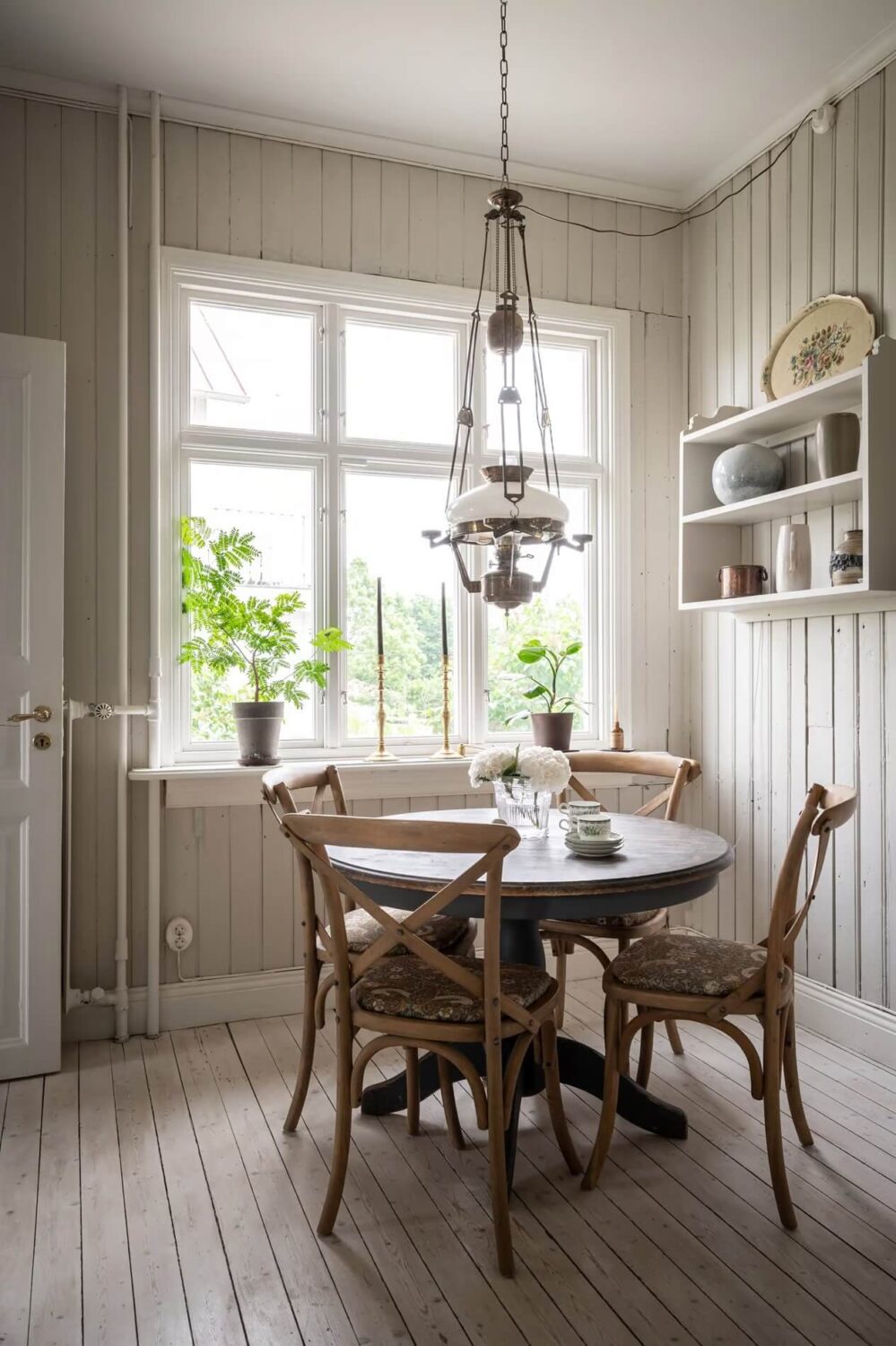 Original Charm in a Light Green Swedish Country House 13 round wooden dining table