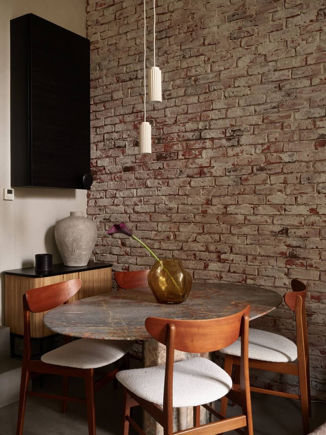 New York Vibes in a Stylish Stockholm Apartment 11 rounded dining table with brick wall