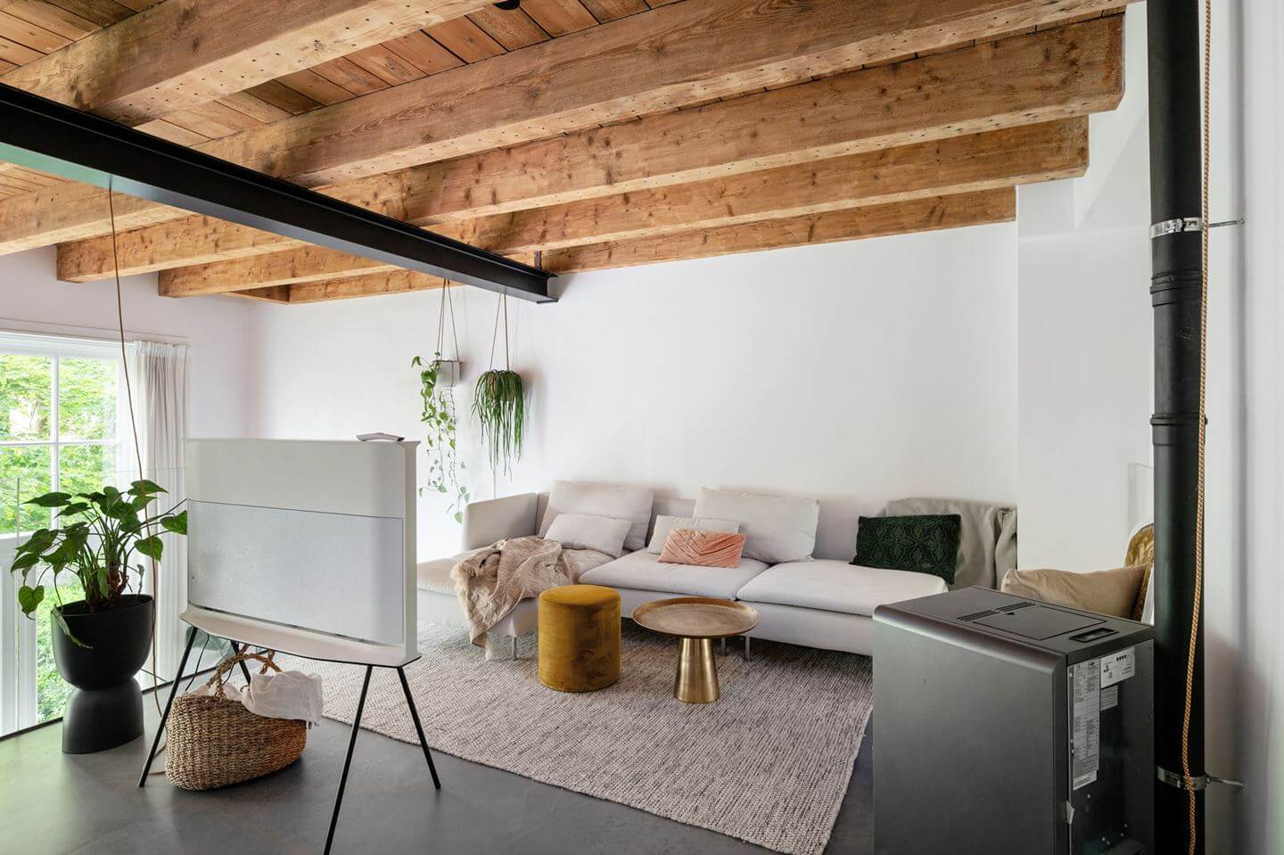 Loft Spaces in a Former School Conversion in Rotterdam 13 sitting room with exposed wooden ceiling