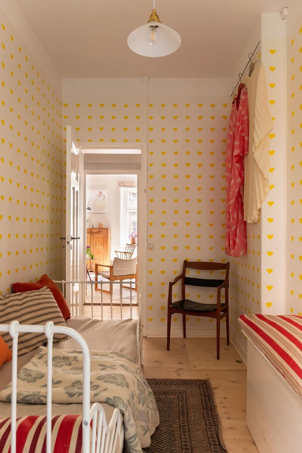 Light and Charming Rooms in a Historic Stockholm Apartment 14 small bedroom with red accents and yellow heart wallpaper nordroom