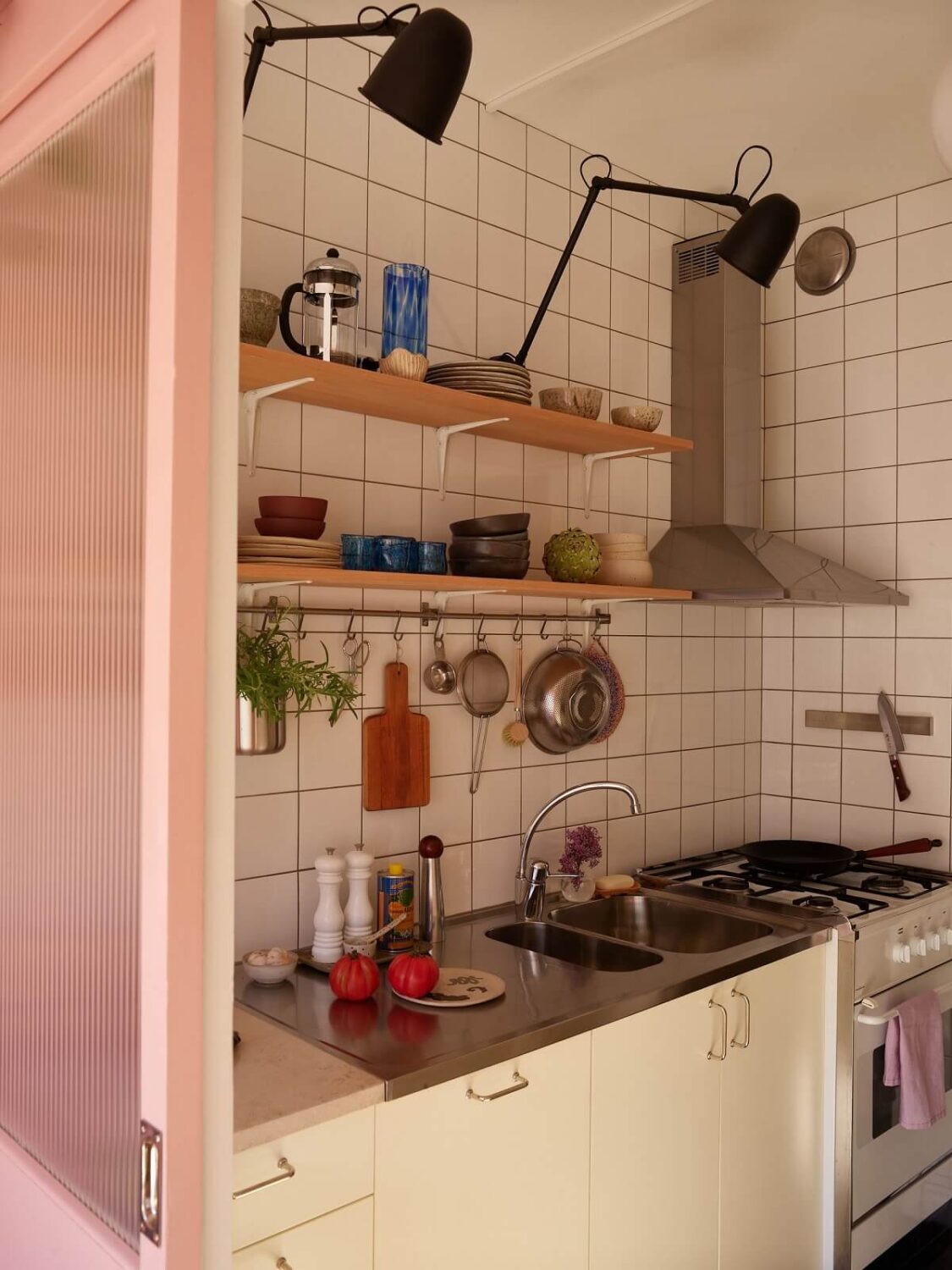 A Small Light Filled Apartment with Plants and Color 17 small kitchen white tiles wooden shelves