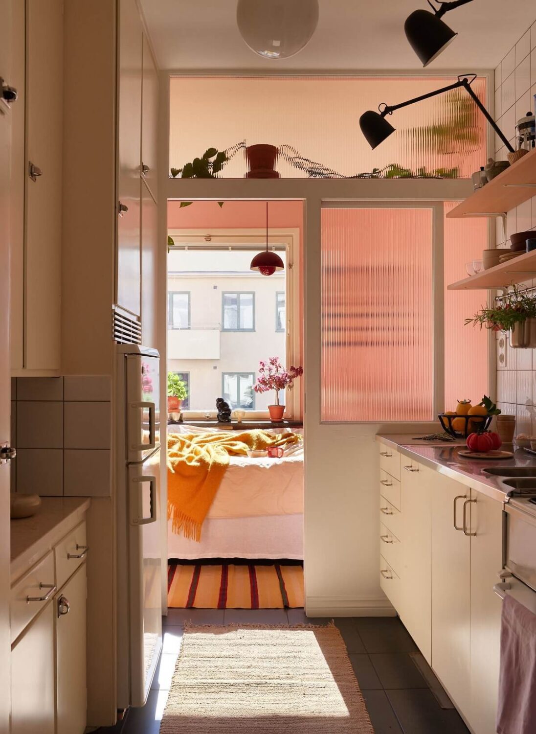 A Small Light Filled Apartment with Plants and Color 15 small kitchen with glass wall to pink bedroom nordroom