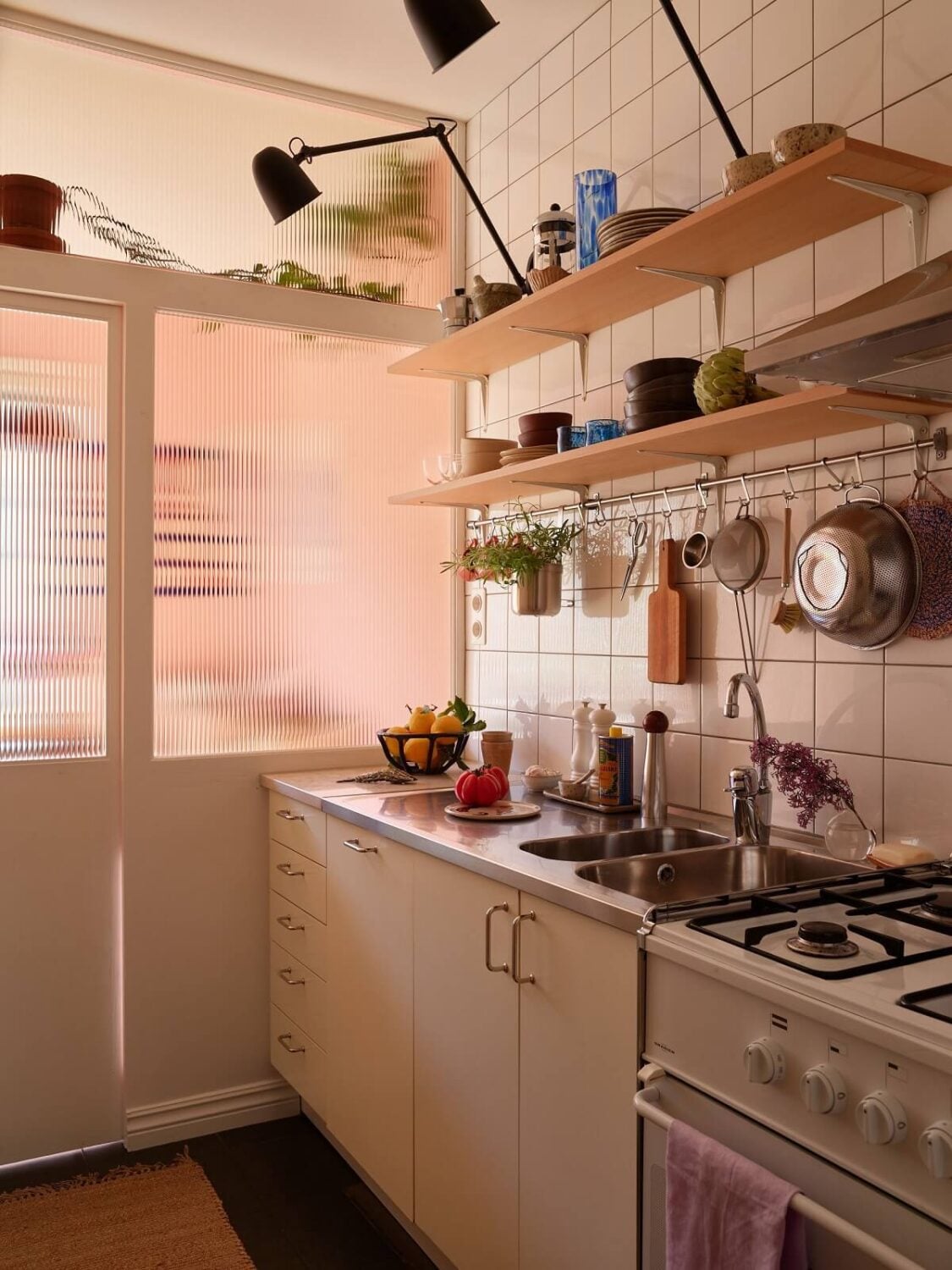 A Small Light Filled Apartment with Plants and Color 16 small kitchen with wooden shelves nordroom