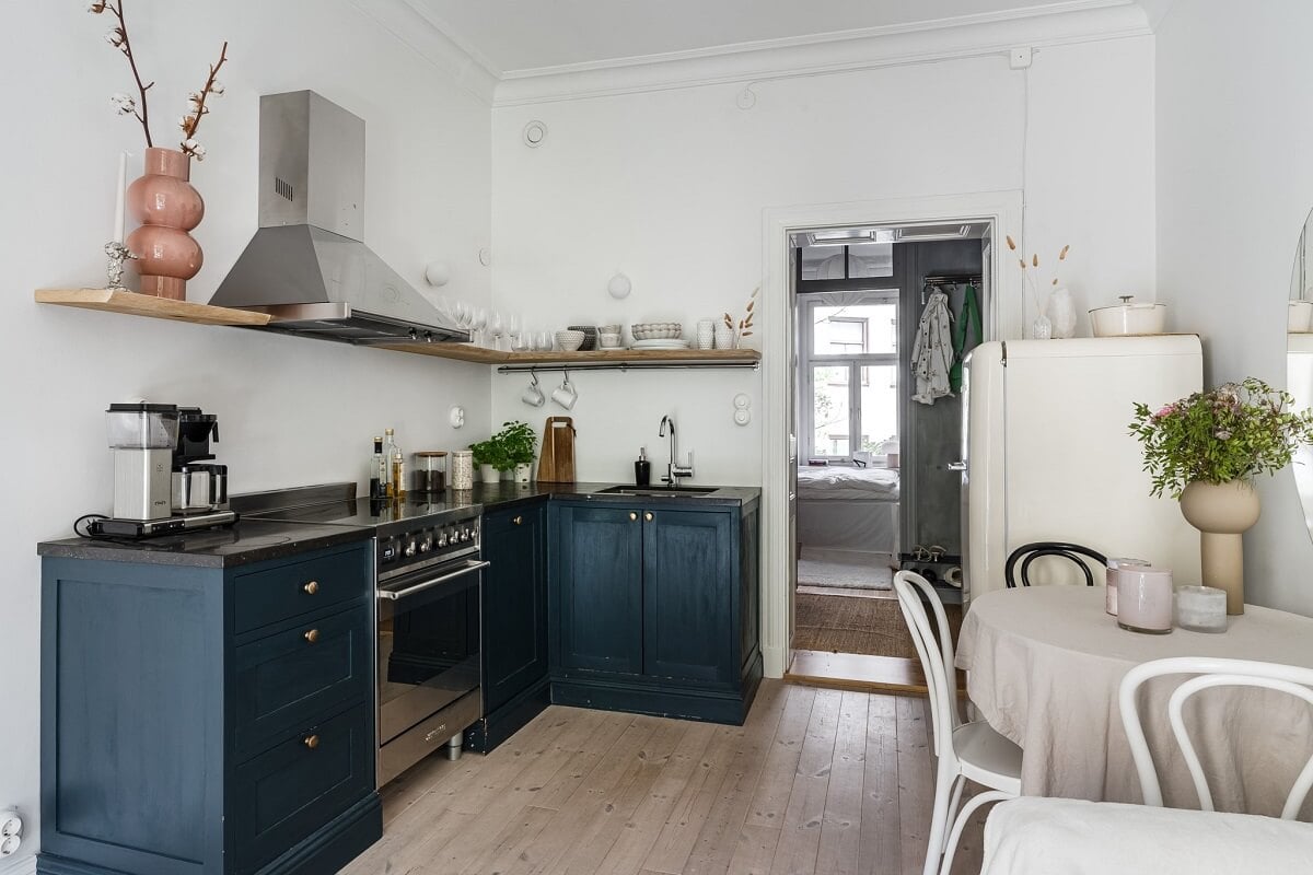 A Small Stockholm Apartment with a Gray Bedroom & Sunny Balcony 5 small living room with blue kitchen