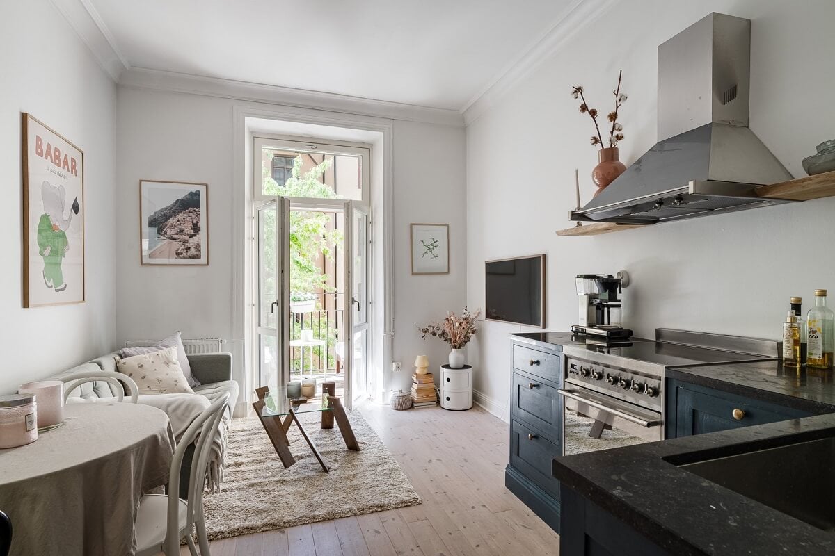 A Small Stockholm Apartment with a Gray Bedroom & Sunny Balcony 1 small open plan living room blue kitchen