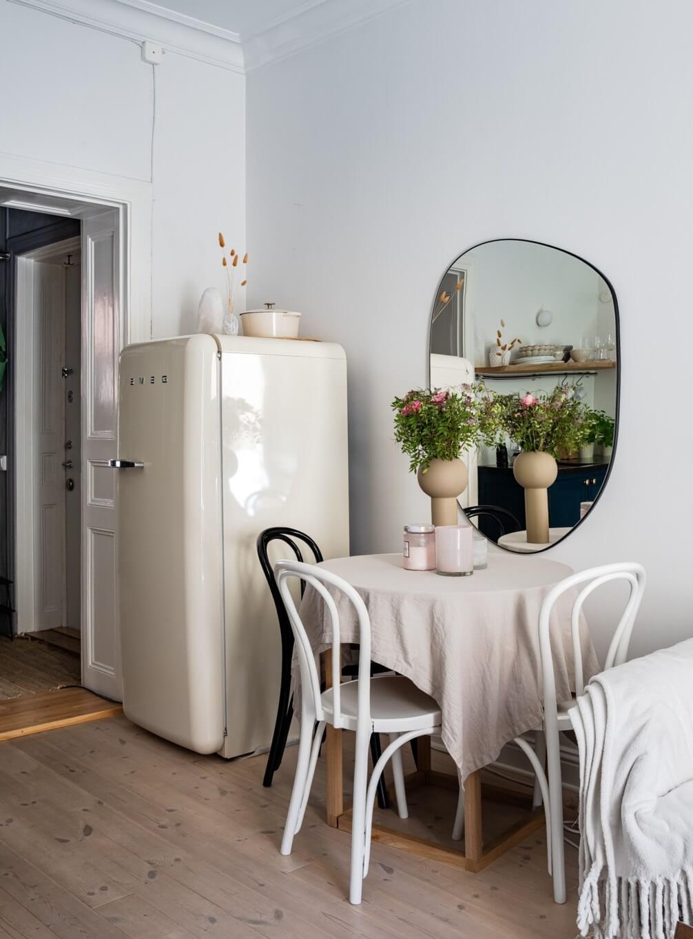 A Small Stockholm Apartment with a Gray Bedroom & Sunny Balcony 6 small table large mirror