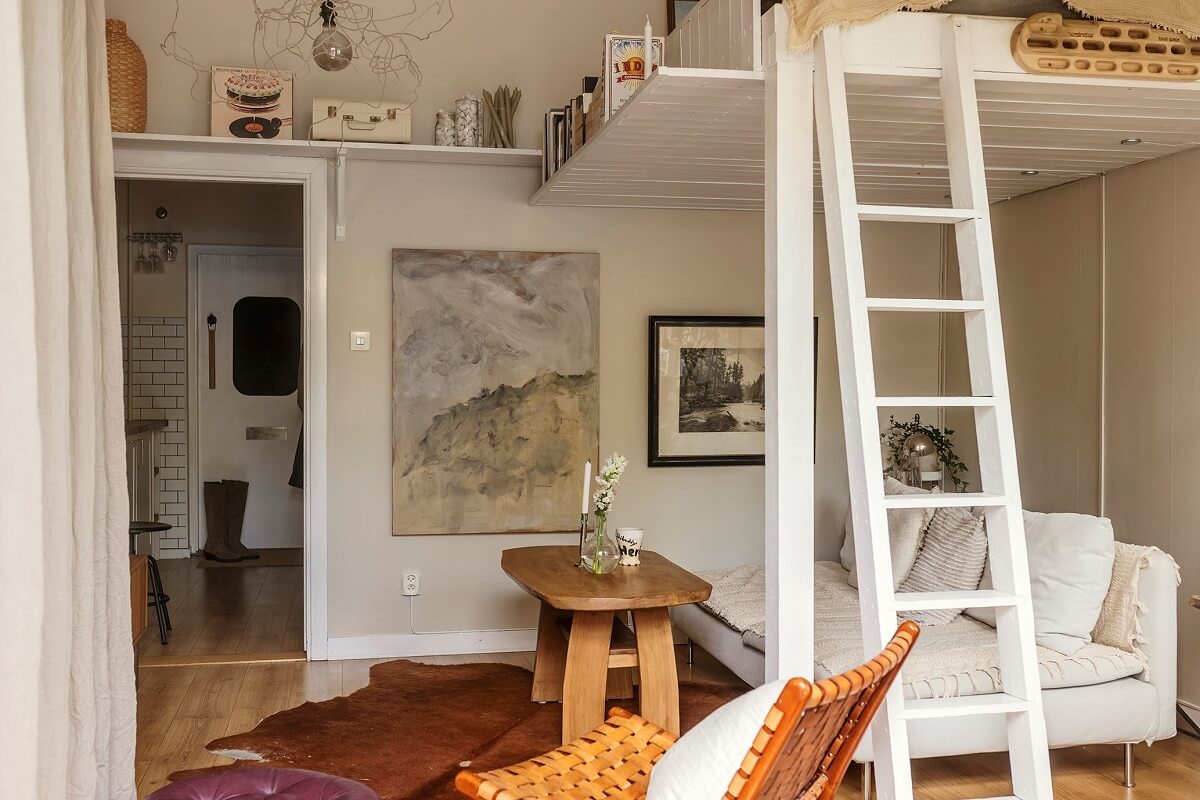 A Charming Studio Apartment with a Loft Bed 1 studio apartment with loft bed and seating underneath