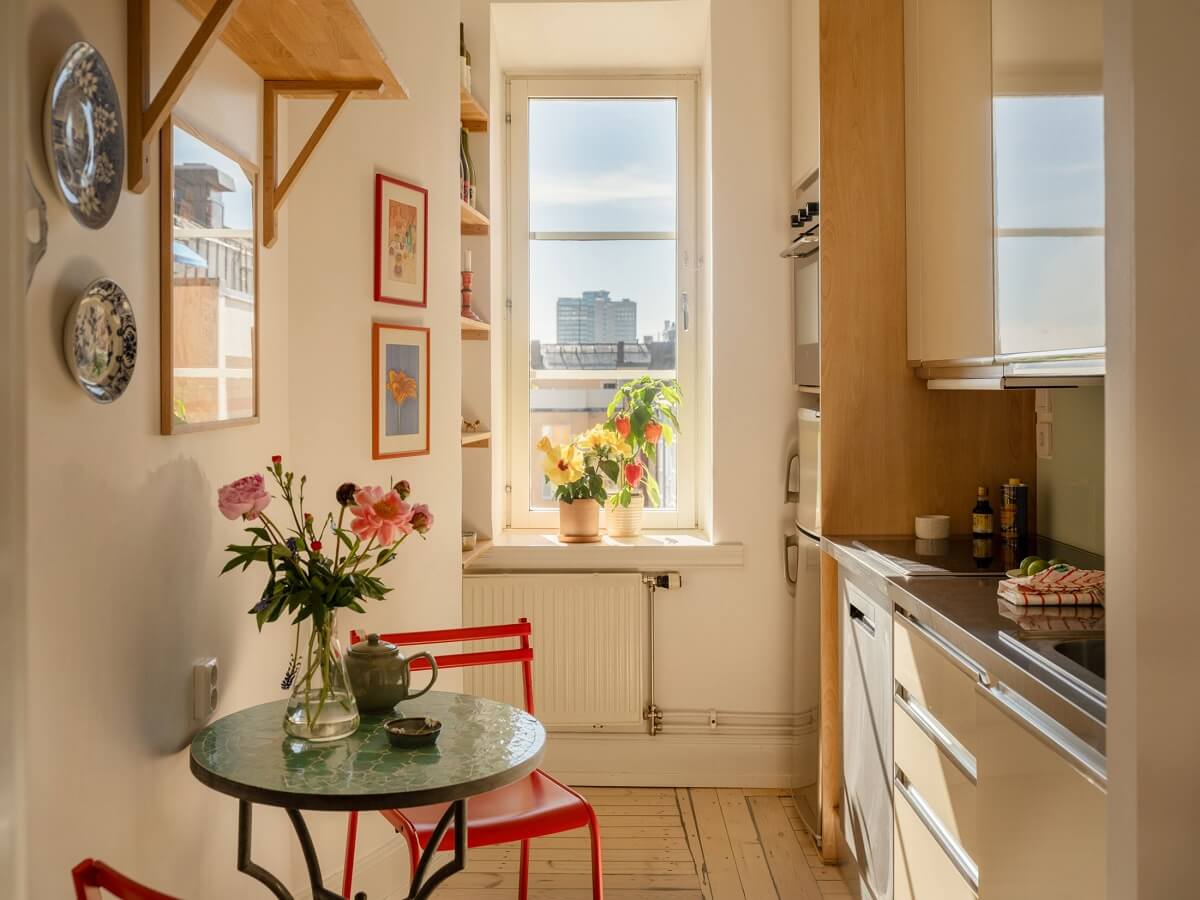 A Light Apartment with a Sunny Balcony 8 sunny kitchen with small round table and red chairs
