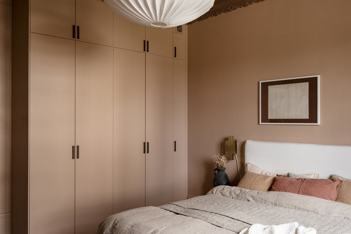 Warm Colors and Painted Ceilings in a Swedish Apartment 13 warm bedroom built in wardrobes