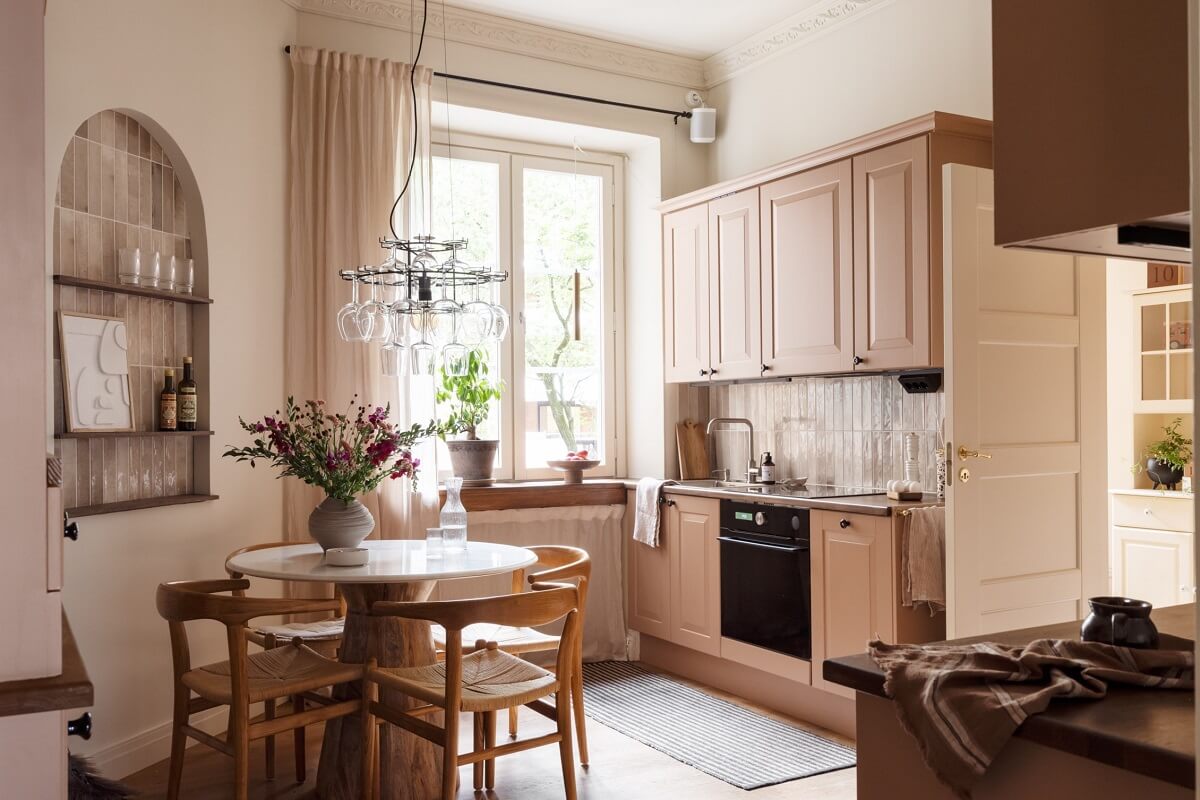 Warm Colors and Painted Ceilings in a Swedish Apartment 4 warm neutral tones kitchen with round table