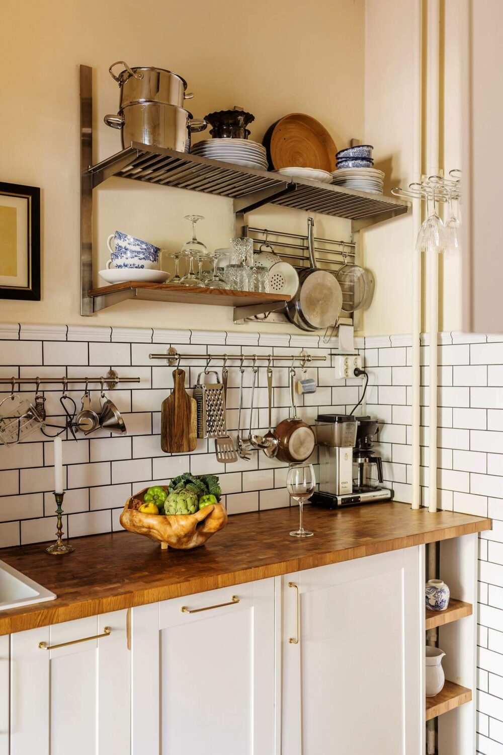 A Charming Studio Apartment with a Loft Bed 9 white kitchen with wooden worktop and subway tiles