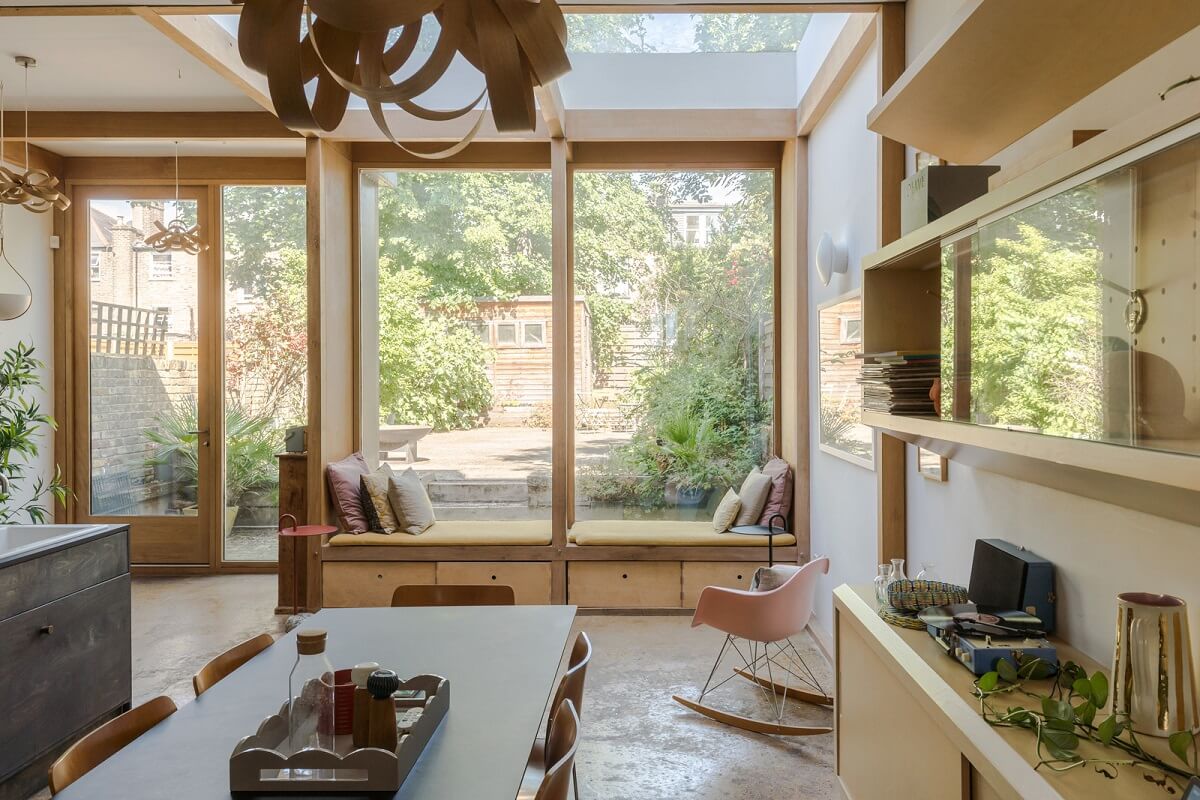 A London Home with an Oak-Framed Glazed Extension 5 wooden kitchen extension skylight window seat