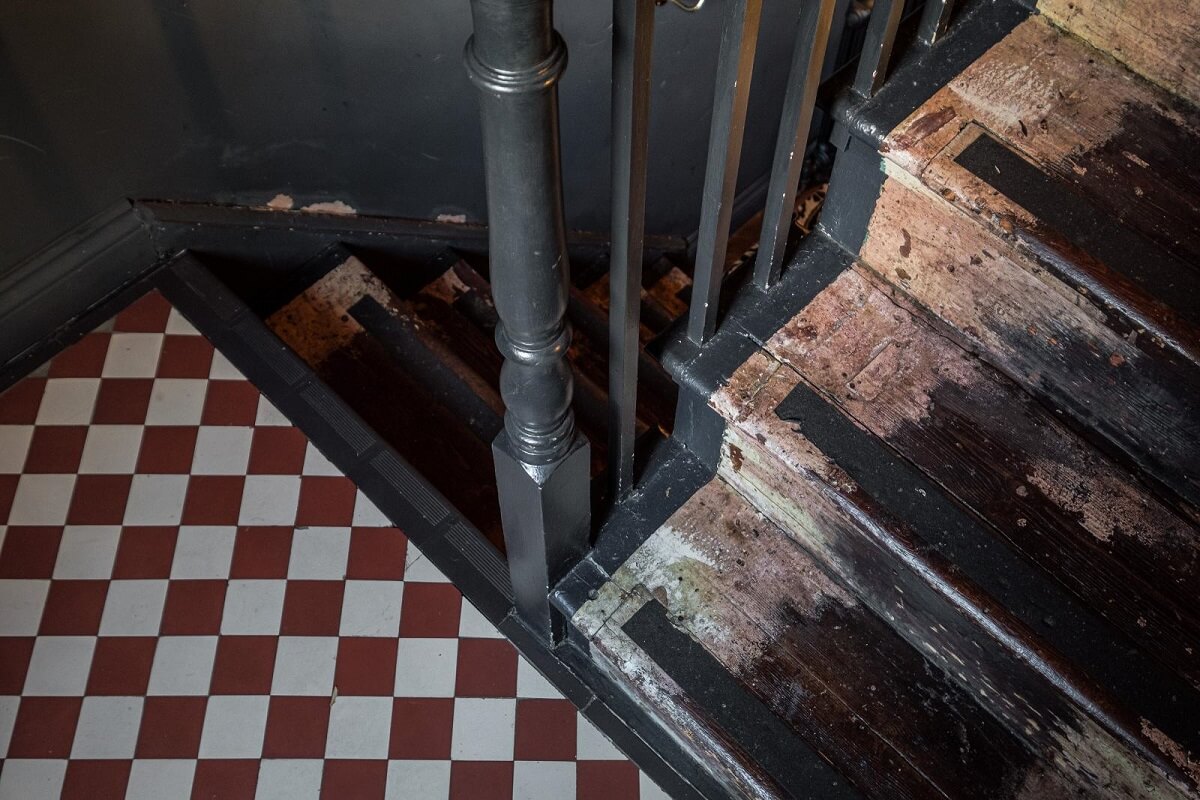 Moody Gray Tones and Period Details in a Victorian Townhouse 12 wooden stairs checkerboard floor