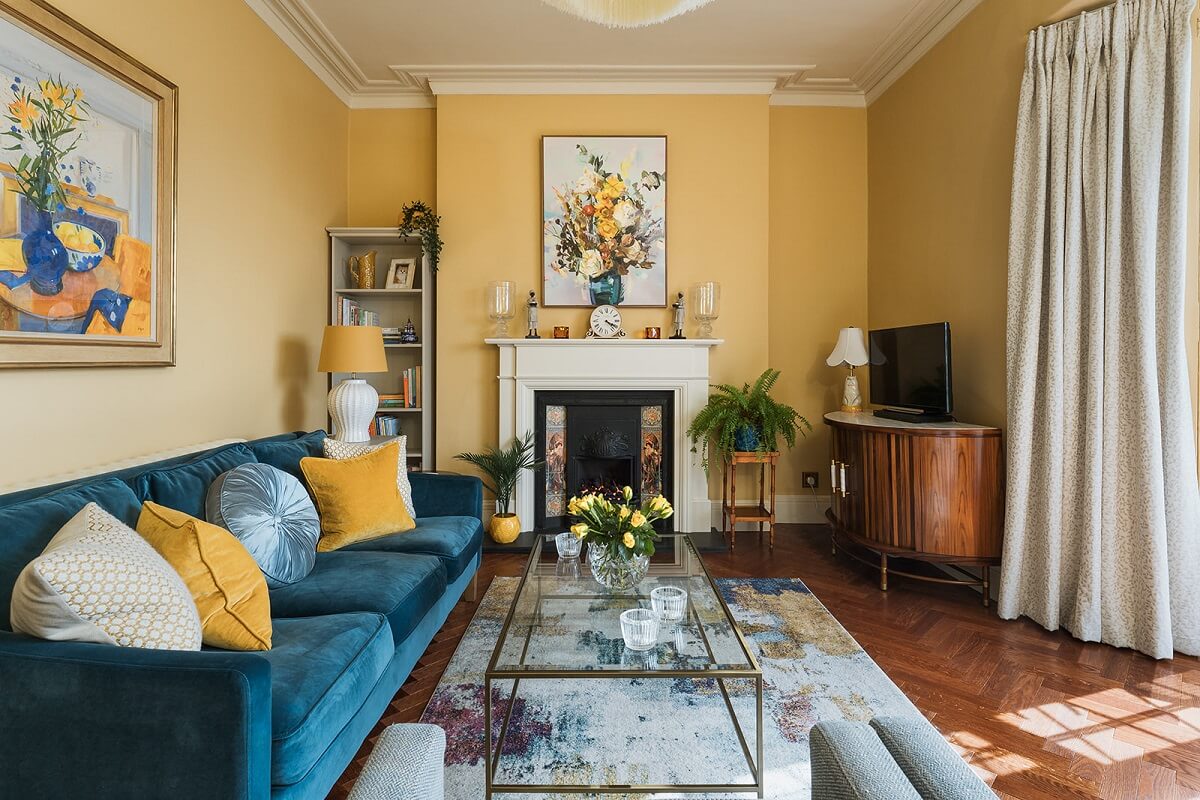 Colorful Interiors and Wallpapers in a Victorian House 1 yellow living room with fireplace