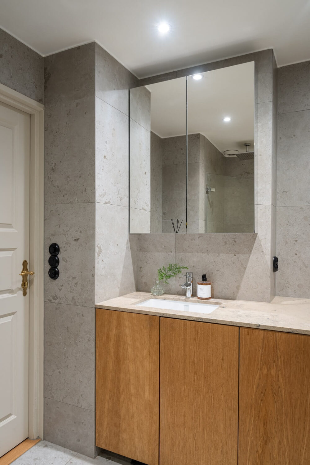 A Renovated Turn-of-the-Century Apartment with Two Bedrooms 22 bathroom gray tiles wooden vanity
