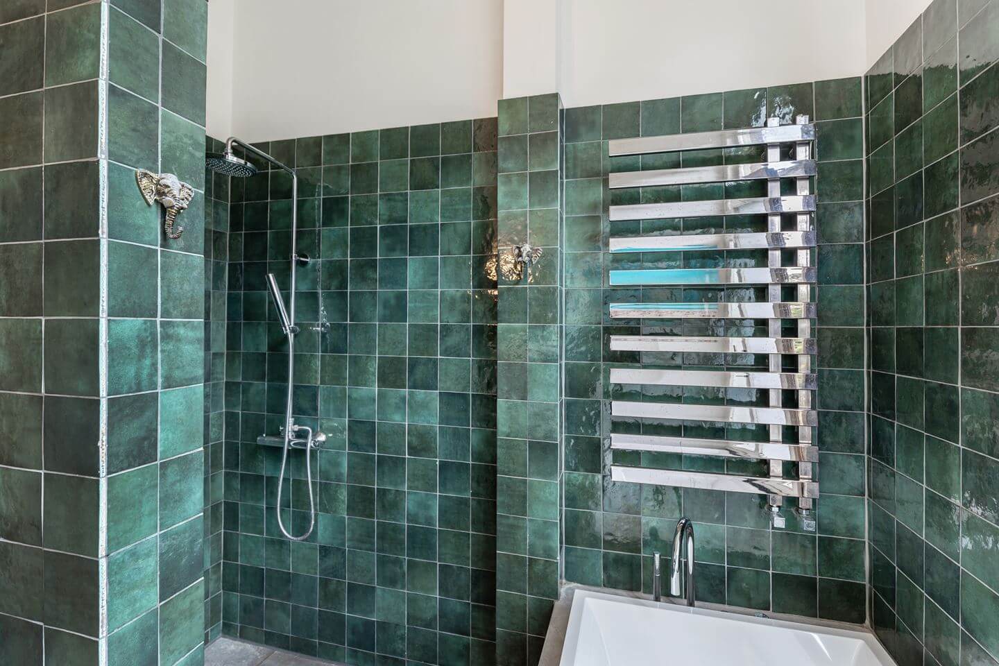 A Beautiful Renovated Duplex Apartment in Amsterdam 22 bathroom shower with green tiles