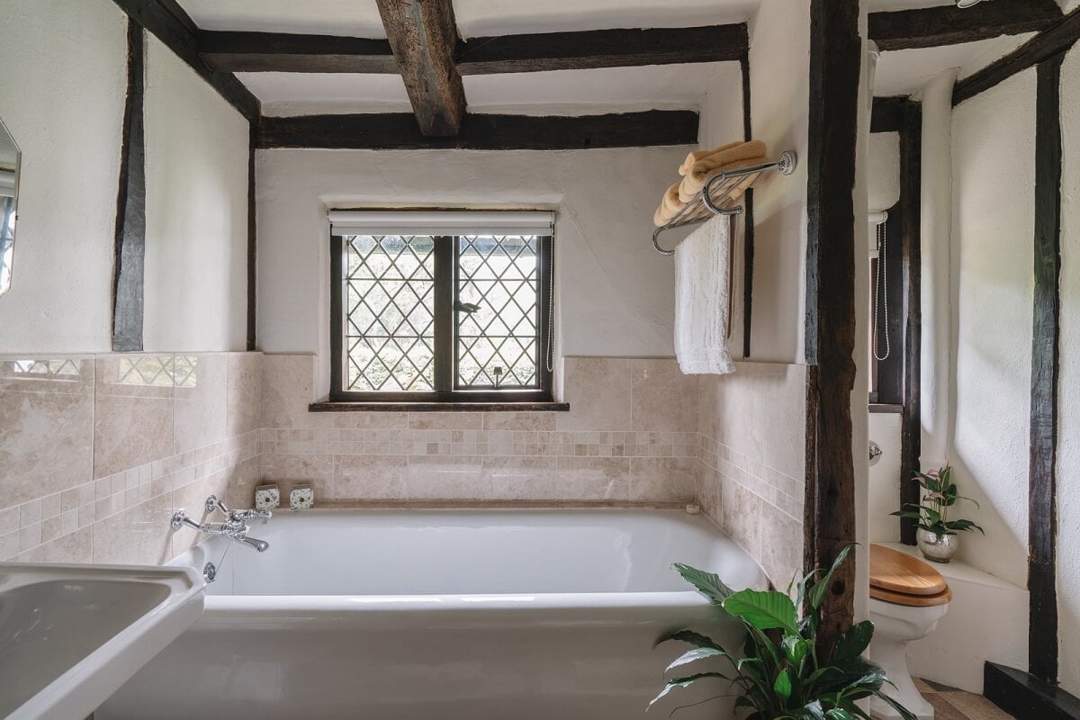 Magnificent Period Features in an English Tudor House 21 bathroom with exposed beams