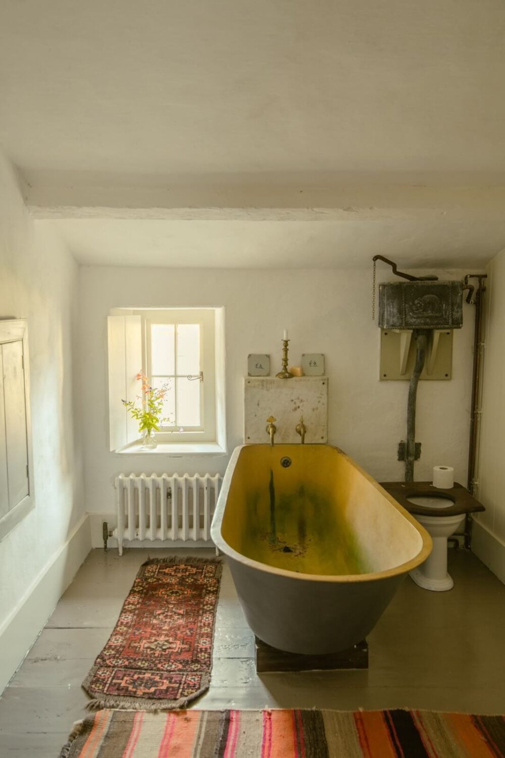 A Yellow Farmhouse with Bold Color Pops in Wales 23 bathroom with freestanding bath