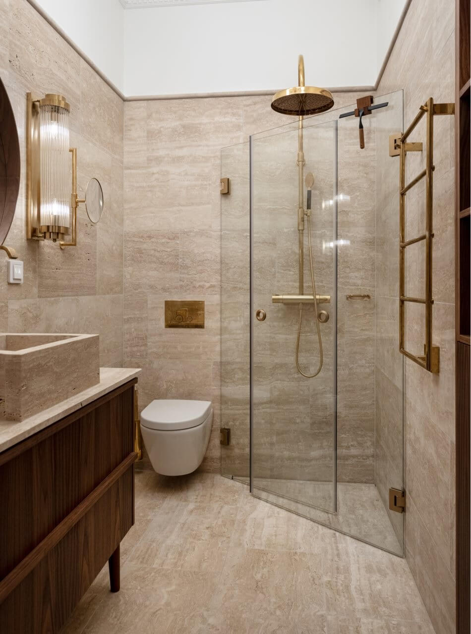 A Luxurious Stockholm Apartment with Period Features 21 bathroom with shower travertine tiles brass fittings
