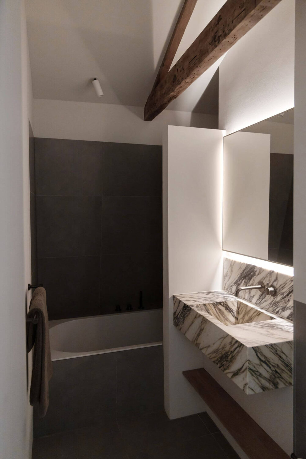 An Apartment with High Pitched Ceilings in an Amsterdam Canal House 13 bathroom wooden beams marble sink nordroom