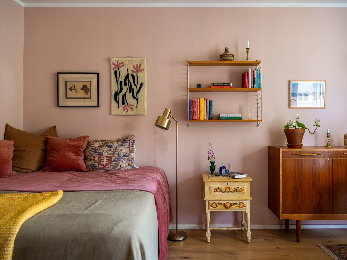 A Studio Apartment with Light Pink Walls and Vintage Furniture 7 bed in studio apartment light pink walls midcentury furniture