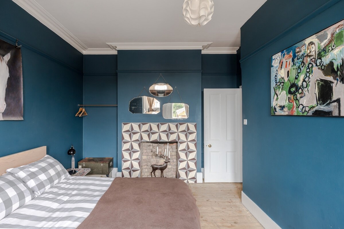 Pared-Back Interiors in a Late Victorian House 12 bedroom dark blue walls fireplace