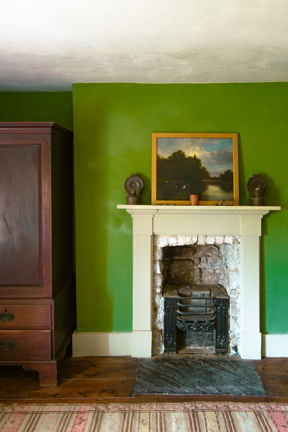 A Yellow Farmhouse with Bold Color Pops in Wales 20 bedroom green walls fireplace