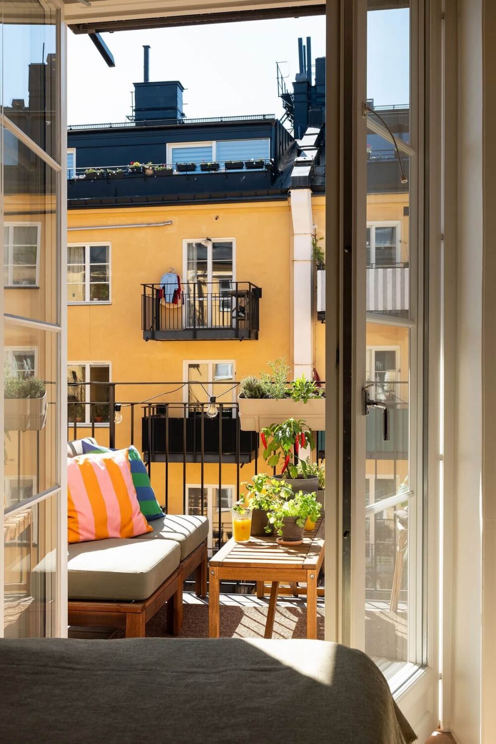 A Renovated Stockholm Apartment with Subtle Color Details 20 bedroom view to balcony