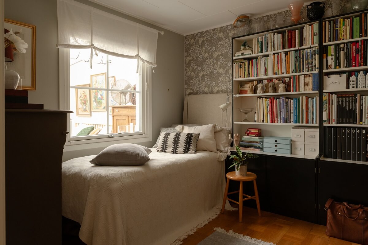 A Swedish Family Home with a Lovely Garden Room 13 bedroom with bookcases and wallpaper