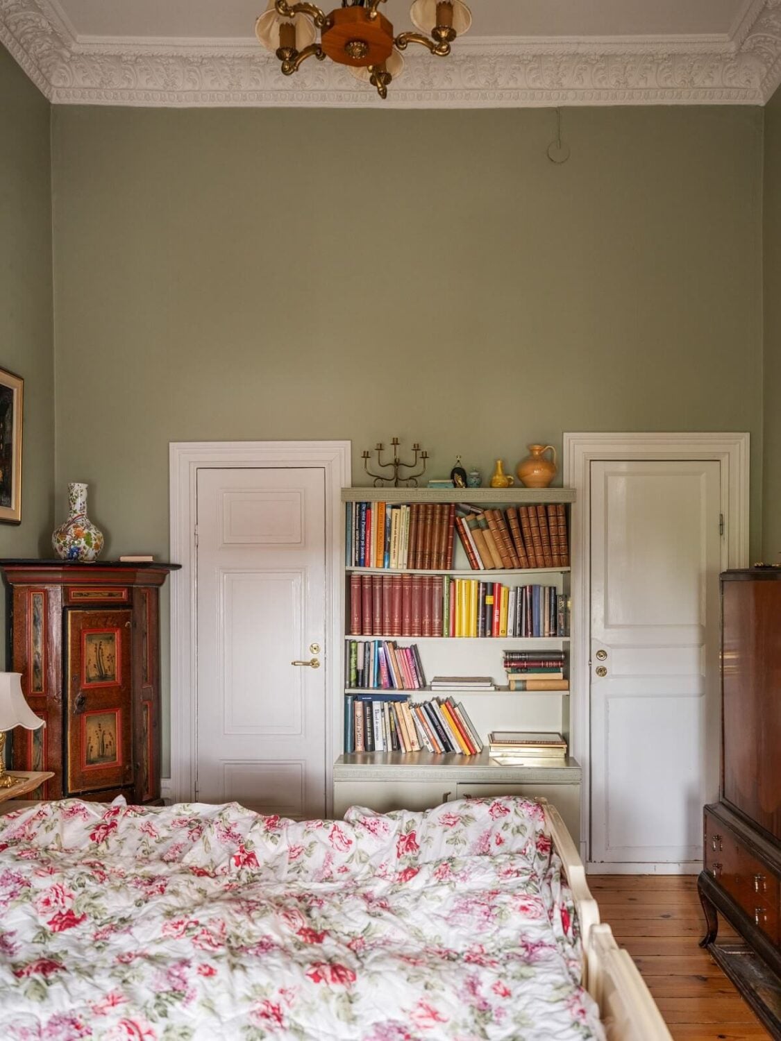 Antique Furniture and Arched Windows in a Stockholm Apartment 18 bedroom with bookshelves and antique furniture
