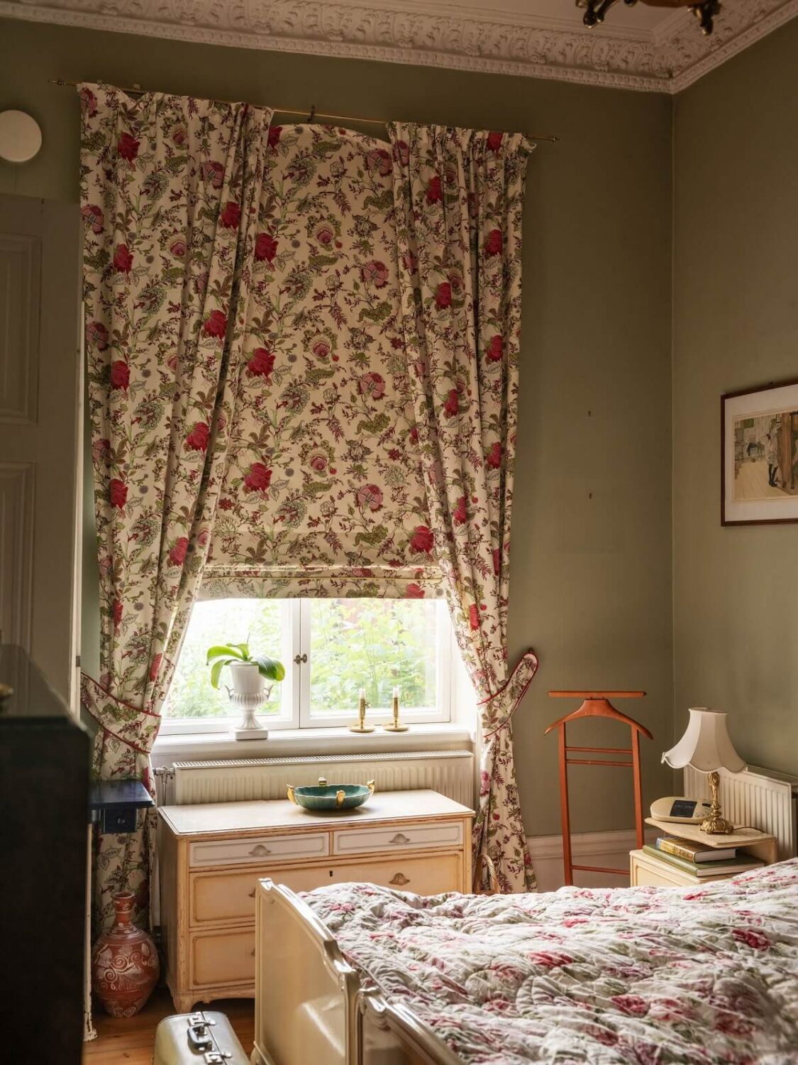 Antique Furniture and Arched Windows in a Stockholm Apartment 16 bedroom with floral curtains