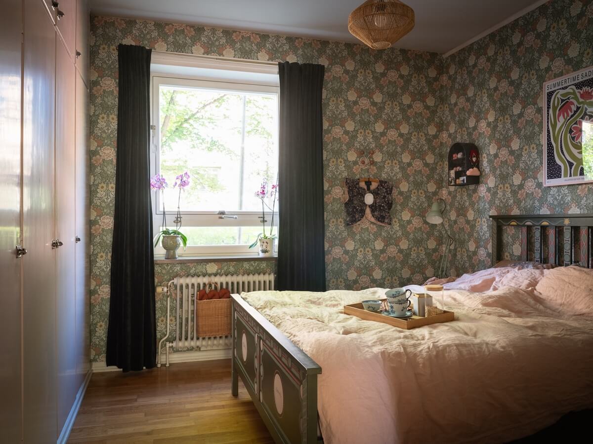Floral Wallpaper and a Pink Kitchen in a Midcentury Apartment 16 bedroom-with-floral-wallpaper-and-built-in-wardrobes