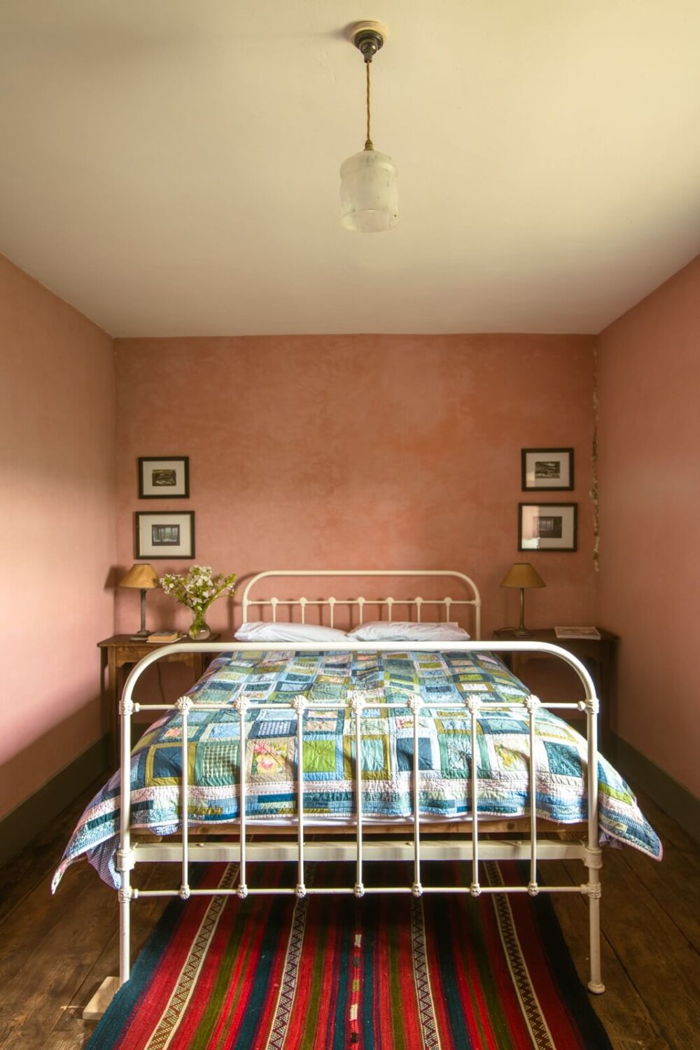 A Yellow Farmhouse with Bold Color Pops in Wales 17 bedroom with pink plaster walls