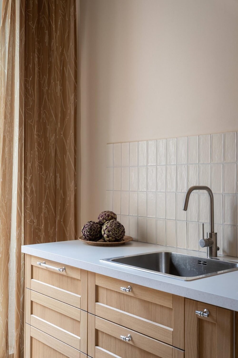 An Elegant Small Renovated Apartment in Stockholm 7 beige tiles and oak kitchen cabinets