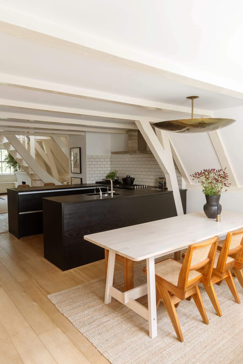 An Apartment with High Pitched Ceilings in an Amsterdam Canal House 7 black kitchen and dining space amsterdam apartment