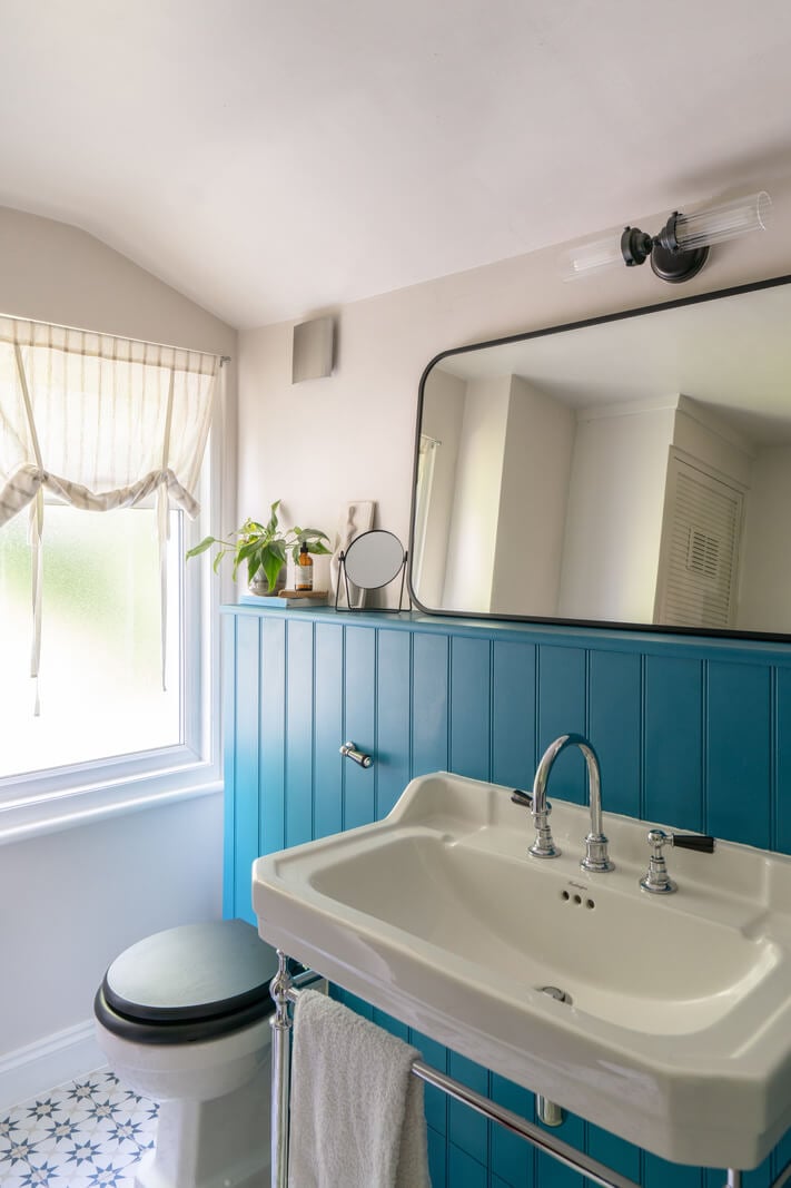 Blue Tones in a Two-Bedroom Victorian Cottage 13 blue paneling bathroom