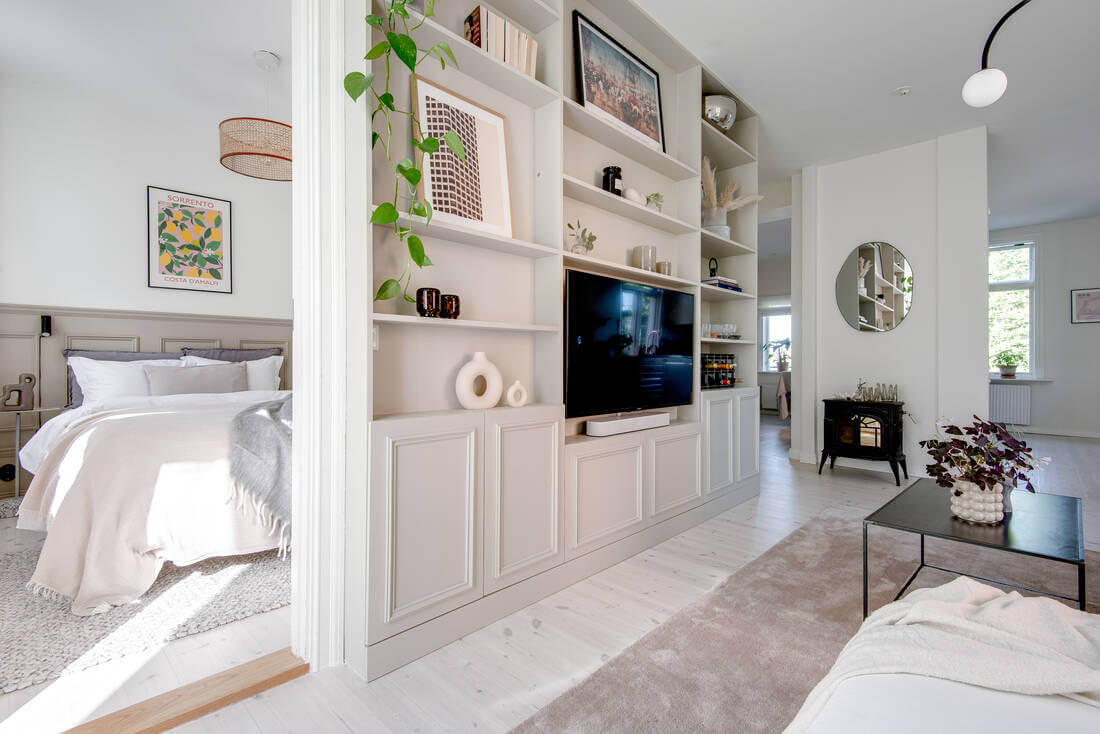 A White Apartment Features a Beautiful Terrace with a View 9 built in cabinets living room