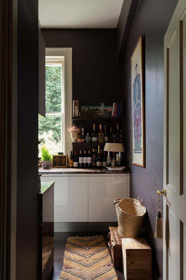A Moody Color Palette and Eclectic Interiors in a London Apartment 7 dark kitchen walls with white cabinets nordroom