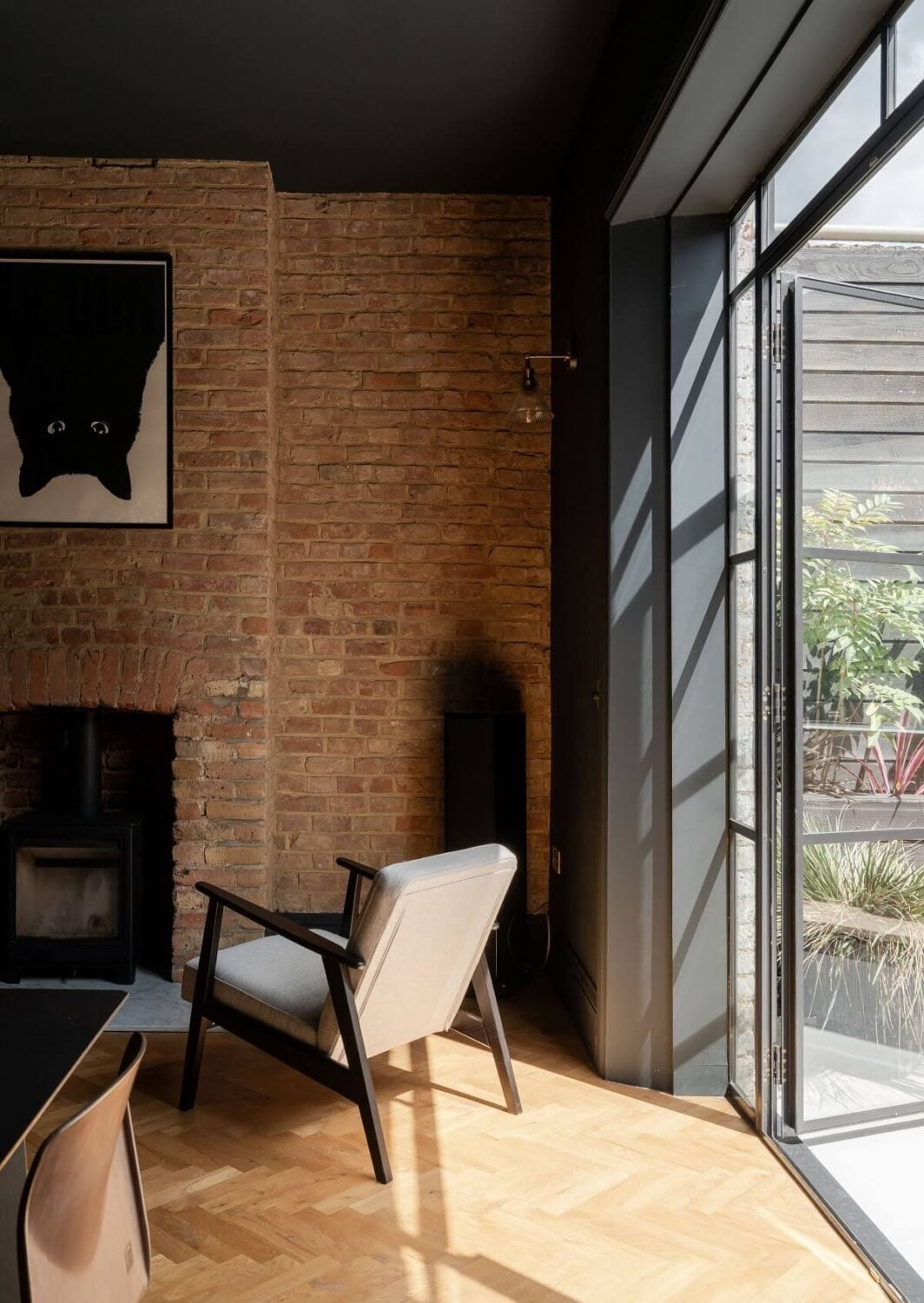 A Stunning Color Palette in an Extended Edwardian House in London 9 dining room with brick wall and black ceiling nordroom