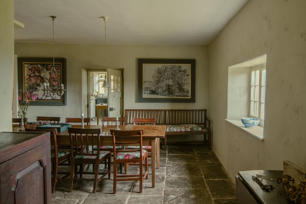 A Yellow Farmhouse with Bold Color Pops in Wales 11 dining room with stone floor