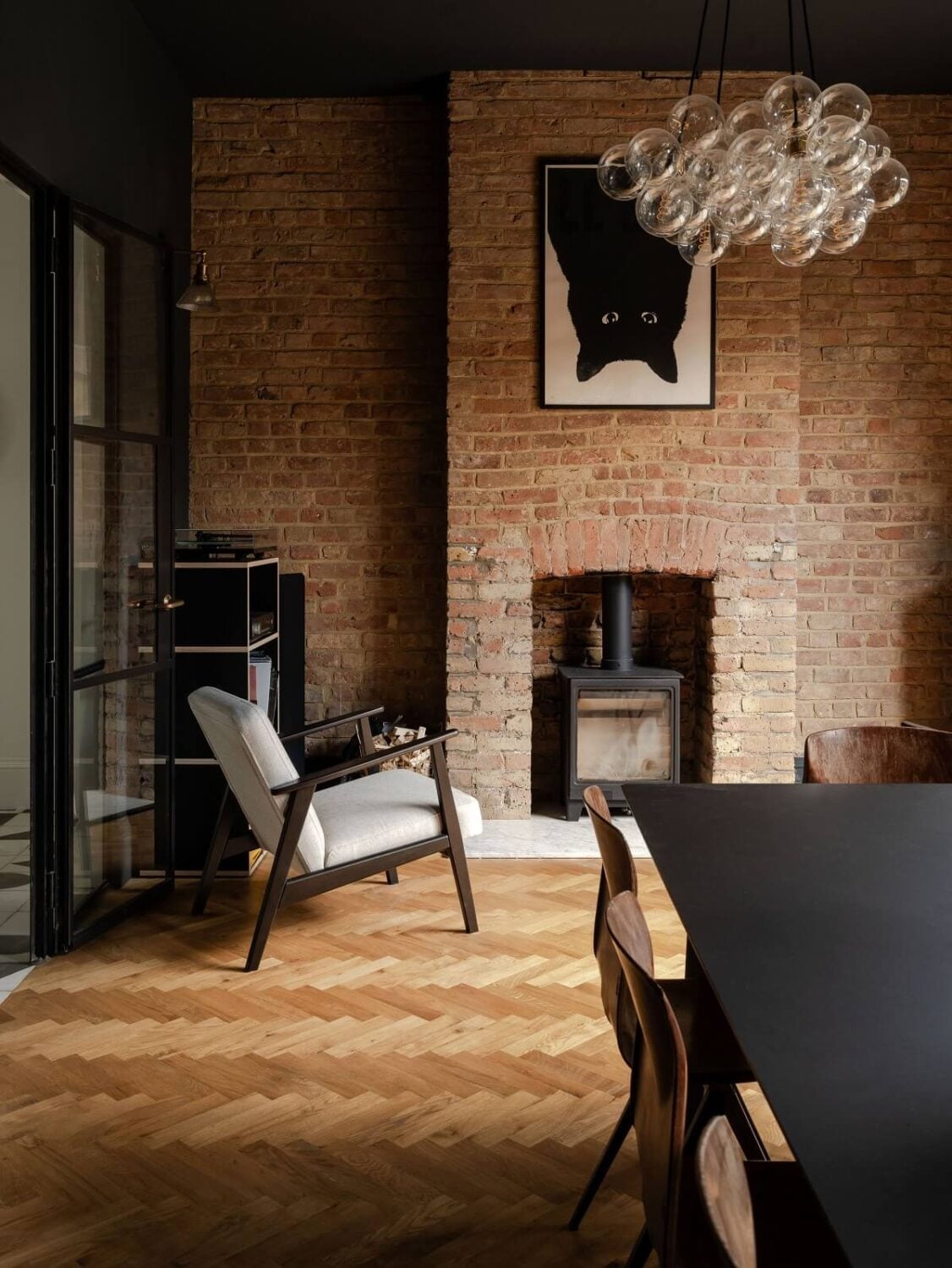 A Stunning Color Palette in an Extended Edwardian House in London 10 dining room with wooden floor black ceiling and brick wall nordroom