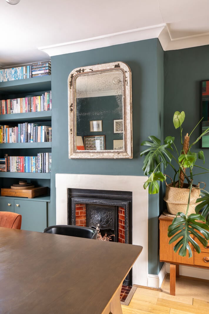 Blue Tones in a Two-Bedroom Victorian Cottage 7 dining space with fireplace