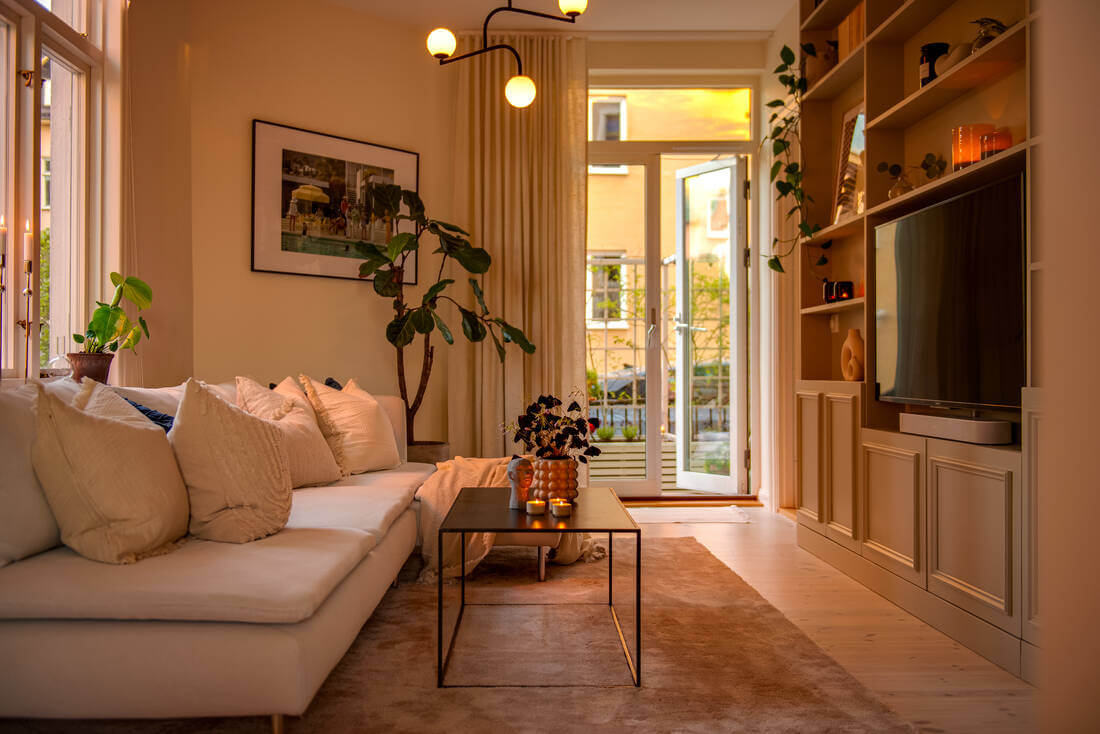 A White Apartment Features a Beautiful Terrace with a View 2 evening light in scandinavian living room