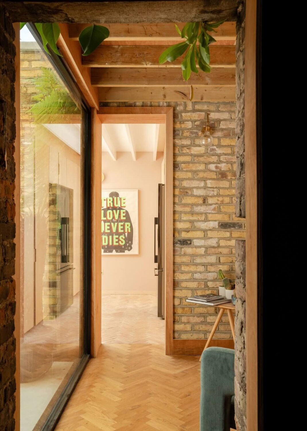 A Stunning Color Palette in an Extended Edwardian House in London 13 exposed brick wall and ceiling beams