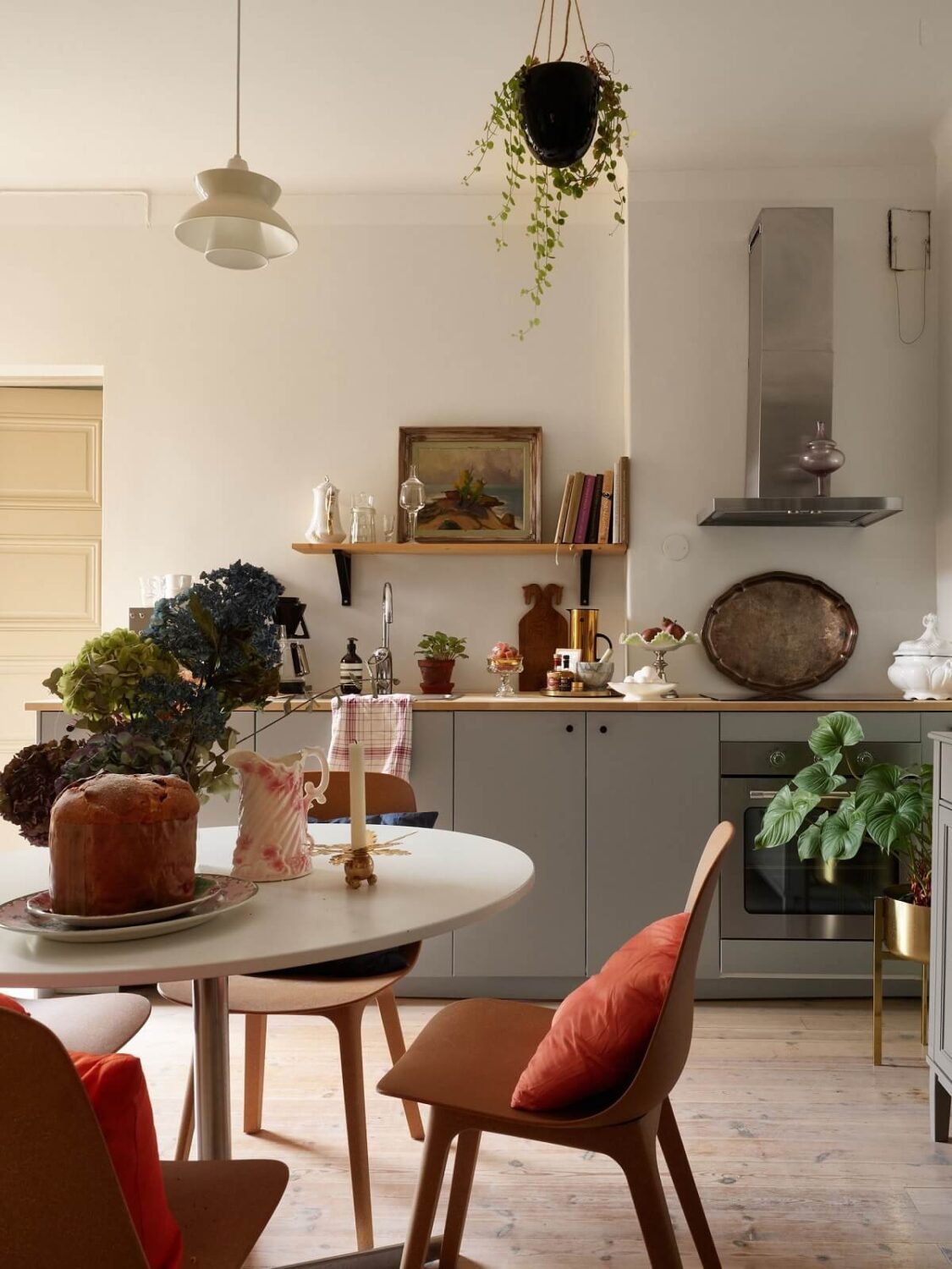 A Charming 1920s Apartment with a Green Bedroom 2 gray kitchen cabinets and round breakfast table nordroom