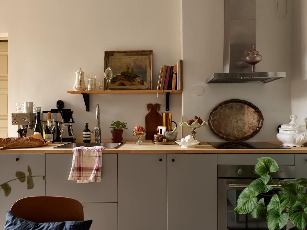 A Charming 1920s Apartment with a Green Bedroom 4 gray kitchen with display shelf
